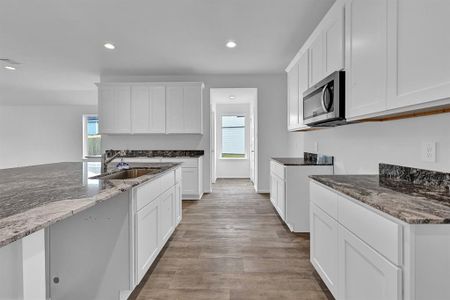 This Gourmet Kitchen will have the Ultra-Modern Tall Shaker Cabinets, Stunning Granite Counters, and Stainless Steel Whirlpool Appliances! **Image representative of plan only and may vary as built**
