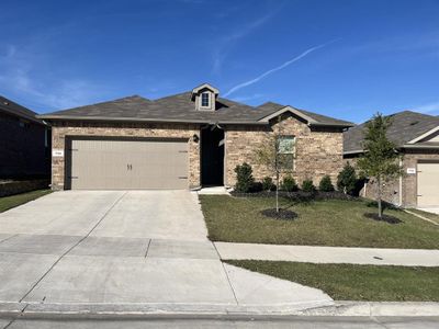 View of front of house featuring a front yard and a garage