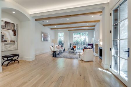 Living room with beam ceiling and light hardwood / wood-style floors