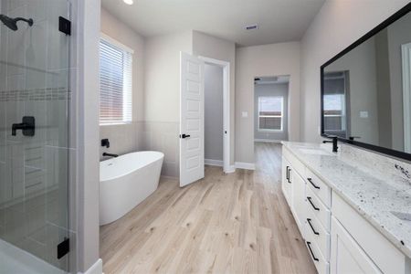 Indulge in the ultimate relaxation experience in this spa-like bathroom, complete with a deep soaking tub, a spacious shower, and sleek modern fixtures, evoking a sense of tranquility.