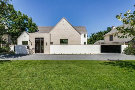 View of front of property featuring a garage and a front yard