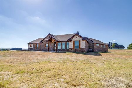 View of front of house with a front yard and central AC unit