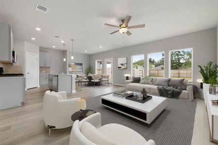 This light and bright spacious living room, with eat in kitchen, is more like a great room and the perfect layout for entertaining or just relaxing. Featuring an extra large Quartz kitchen island, Grey cabinetry, EVP flooring, recessed lighting and additional pendant lighting.