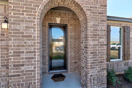 Inviting front entry with an upgraded front door that welcomes you home.