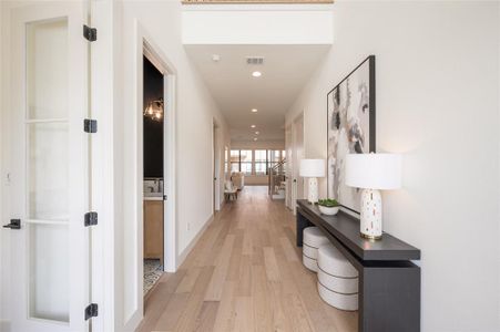 The iron entry doors and a dramatic double-height foyer introduces the 4,788-square-foot elevator-ready home&#39;s soaring ceilings, wide-plank oak floors, oversized aluminum windowsand elegant lighting.