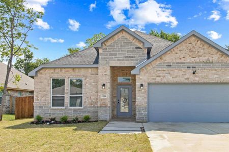 View of front facade featuring a front lawn and a garage