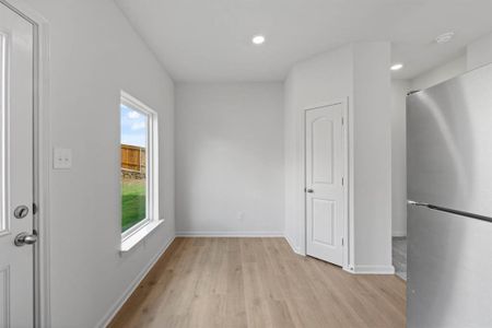 Dining area with light wood-style floors