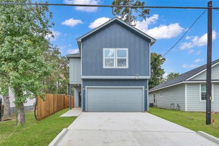 Discover this chic, two-story residence boasting a vibrant blue facade, complete with a spacious attached double garage and a brand-new, private 7-foot wooden fence for your tranquility.