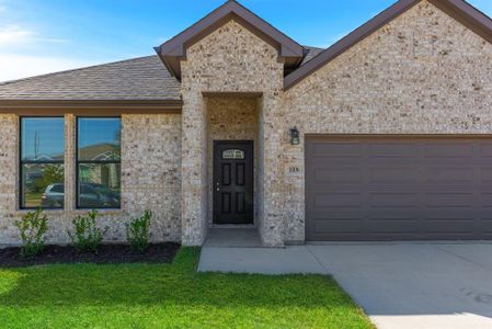 View of front of property with a garage and a front lawn