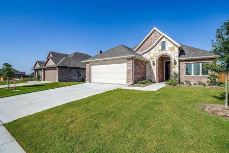 View of front of property featuring a garage and a front yard