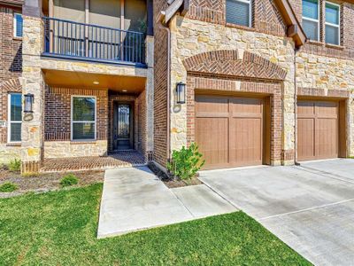 Doorway to property featuring a balcony and a lawn