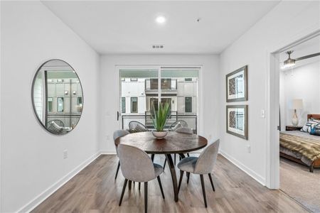 Spacious living area already equipped with hardwood/wood-style flooring, ceiling fan and plasma prep.