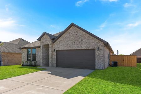 View of front of house with cooling unit, a front yard, and a garage