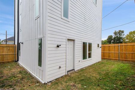 View of side of home featuring a lawn