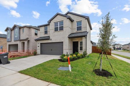 View of front of house featuring a garage and a front yard