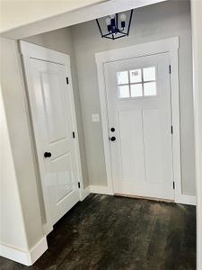 Entryway featuring a notable chandelier and dark hardwood / wood-style floors