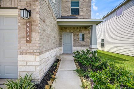 A beautifully landscaped entryway, framed by gorgeous brickwork, warmly welcomes you home.