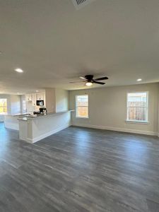 Living room with wood-type flooring, ceiling fan