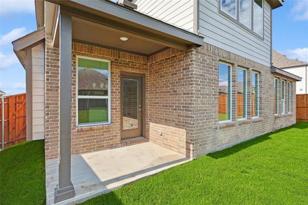 Back of property with a patio and a lawn