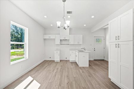 Modern design with quartz countertops, a pantry, and ample natural light.