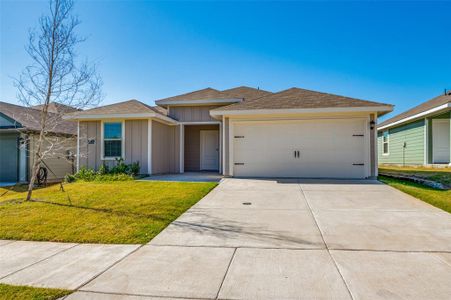 View of front of home with a front lawn and a garage