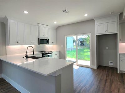 Kitchen featuring stainless steel appliances with kitchen peninsula, great for entertaining