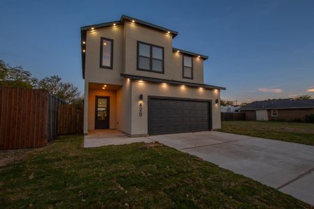 Contemporary home featuring a lawn and a garage