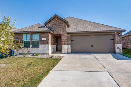 View of front of house with a front lawn and a garage