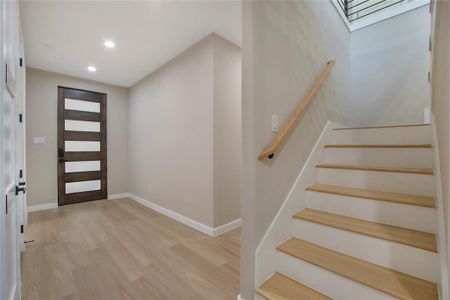 Entrance foyer featuring light hardwood / wood-style flooring and a skylight