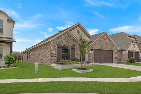 View of front of property featuring a garage and a front yard