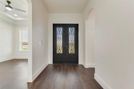 Foyer featuring ceiling fan and dark wood-type flooring