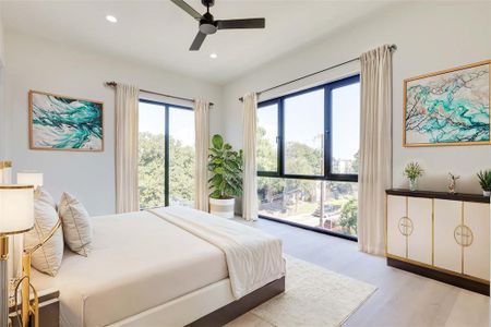 Bedroom with access to exterior, light hardwood / wood-style flooring, and ceiling fan