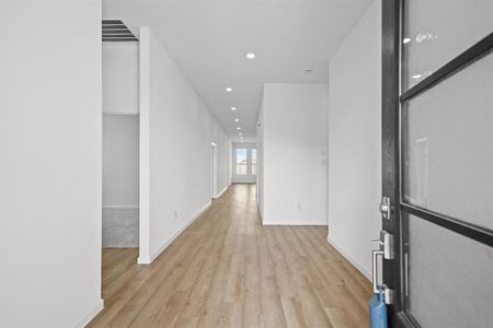 Entryway featuring wood floor, recessed lighting. Designer etched glass and wood front door.