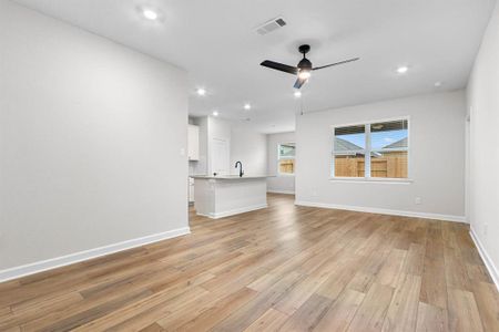 With its open layout, the family room becomes a versatile entertainment area, allowing hosts to entertain guests while preparing meals in the nearby kitchen, ensuring a seamless flow of conversation and enjoyment throughout the space.