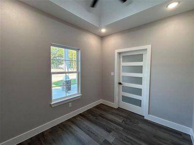 Unfurnished room featuring dark hardwood / wood-style floors