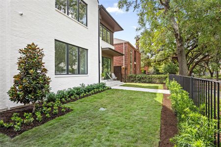 The meticulously manicured lawns, designed by Gregory/Henry Landscapes, feature lush greenery and mature trees that create a welcoming and serene outdoor environment.