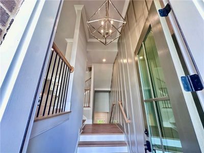 Beautiful chandelier spans two-story front foyer