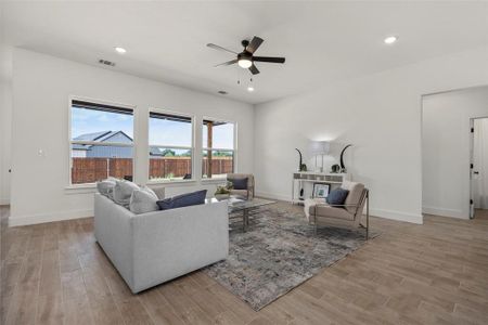 Living room featuring light hardwood / wood-style floors and ceiling fan