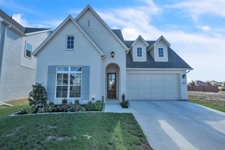 View of front of property with a front yard and a garage