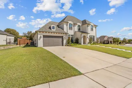 French provincial home featuring a front yard and central AC unit