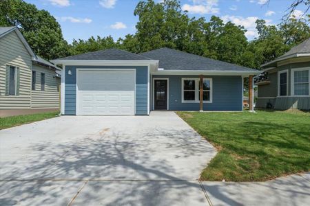 View of front of property with a garage and a front lawn