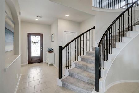 Elegant staircase that leads to a stunning entryway that will welcomed all of your guests to your house.