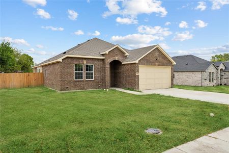 Ranch-style home featuring a garage and a front lawn