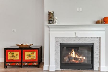 A focal point of the room is the charming fireplace, adding warmth and character to the space.