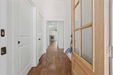 Hall with dark hardwood / wood-style flooring