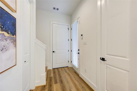 Entry Foyer with closet for storing shoes, vacuum, mop, etc.