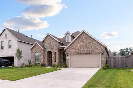 Impressive front view showcasing a spacious driveway leading to the elegant entrance, surrounded by well-maintained landscaping.