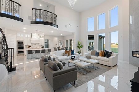 Living room featuring a towering ceiling and a large fireplace