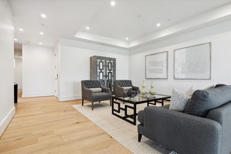 To the left of the entry is the living room with a tray ceiling plenty of space to display your art work.