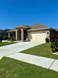 Prairie-style home with a front yard and a garage